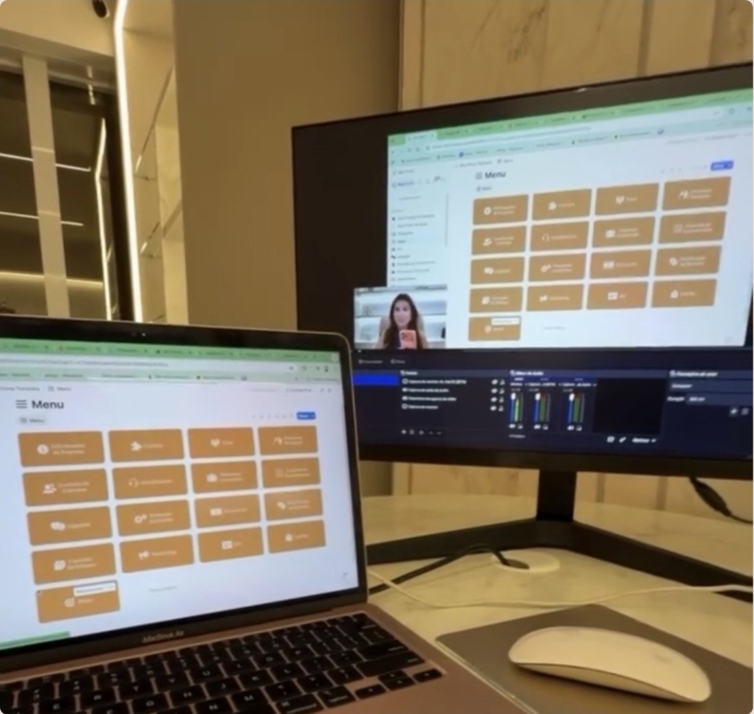 Notebook e monitor na clínica com o painel Gestão à Vista aberto durante uma aula de implementação